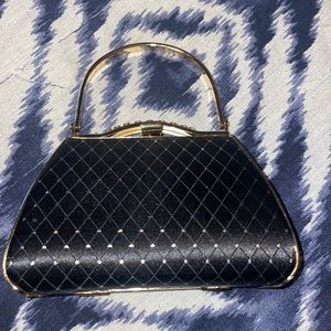 vecelli Italian mini purse, black with gold outlining in perfect condition.